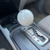 Very large white shift knob installed in a Toyota 4Runner with an automatic transmission.